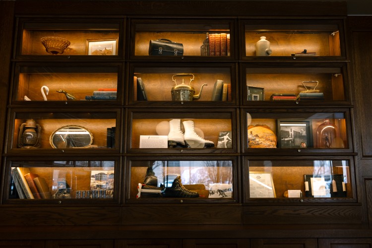 a display case with books and objects on it