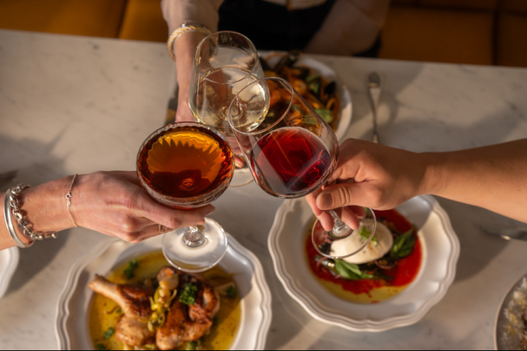 a group of people holding wine glasses