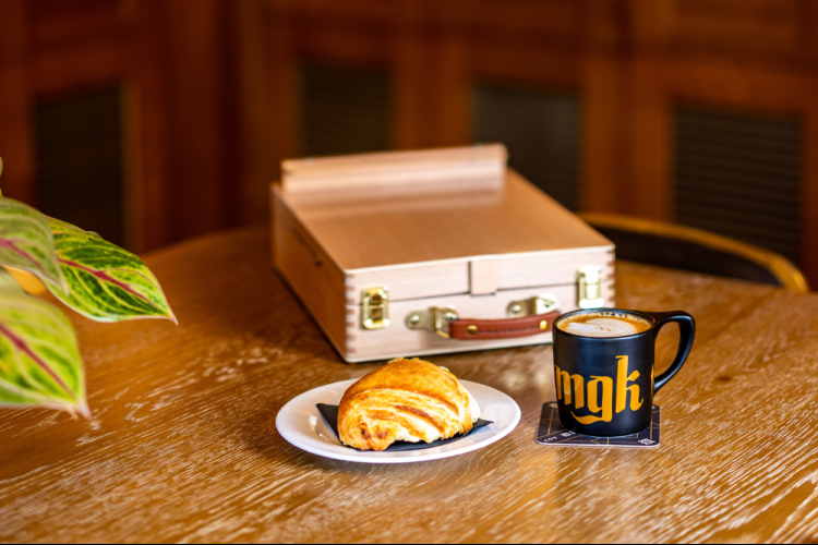 a coffee cup and pastry on a table