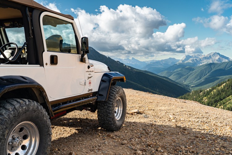 a white jeep on a rocky hill