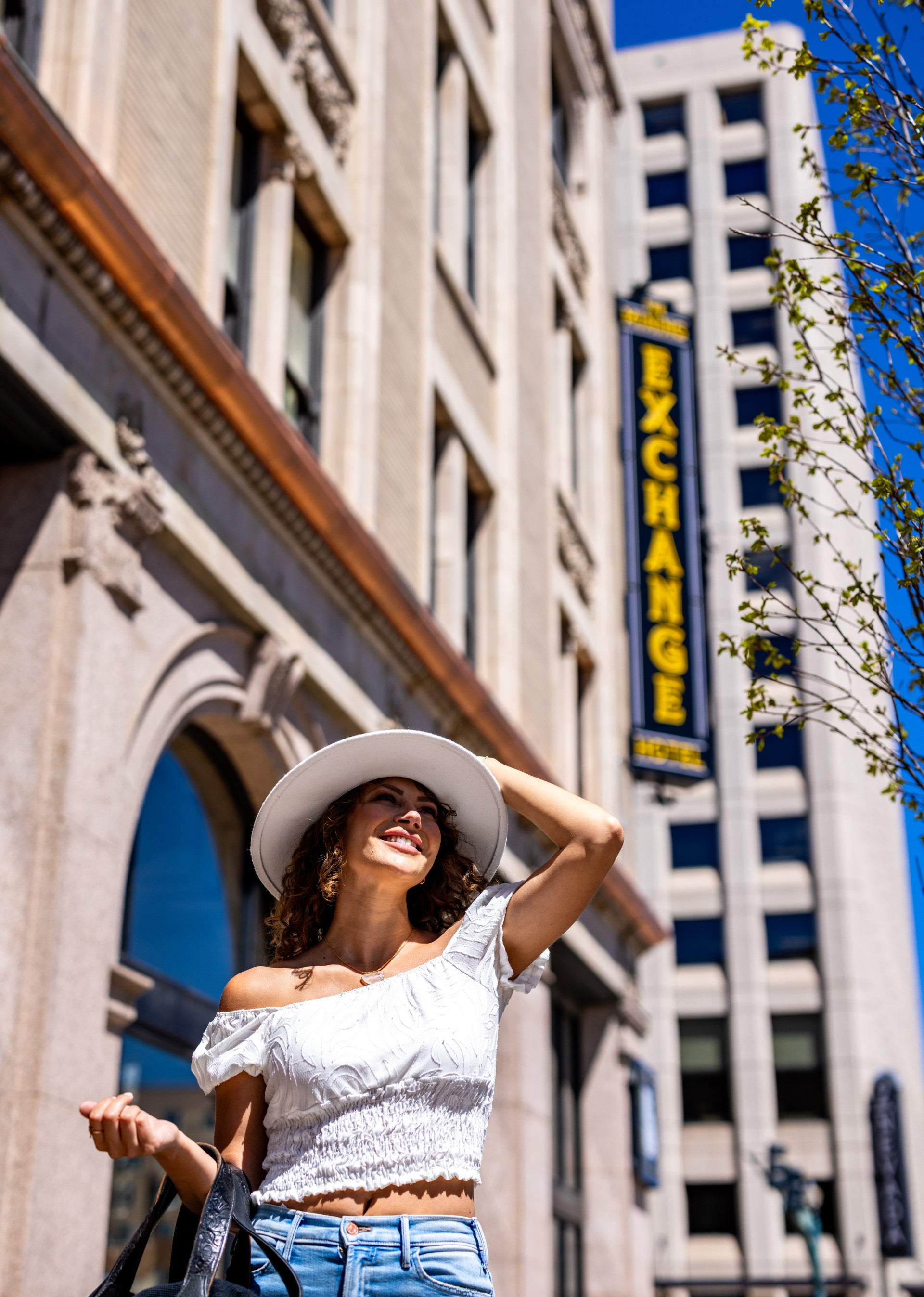a woman in a white dress and hat