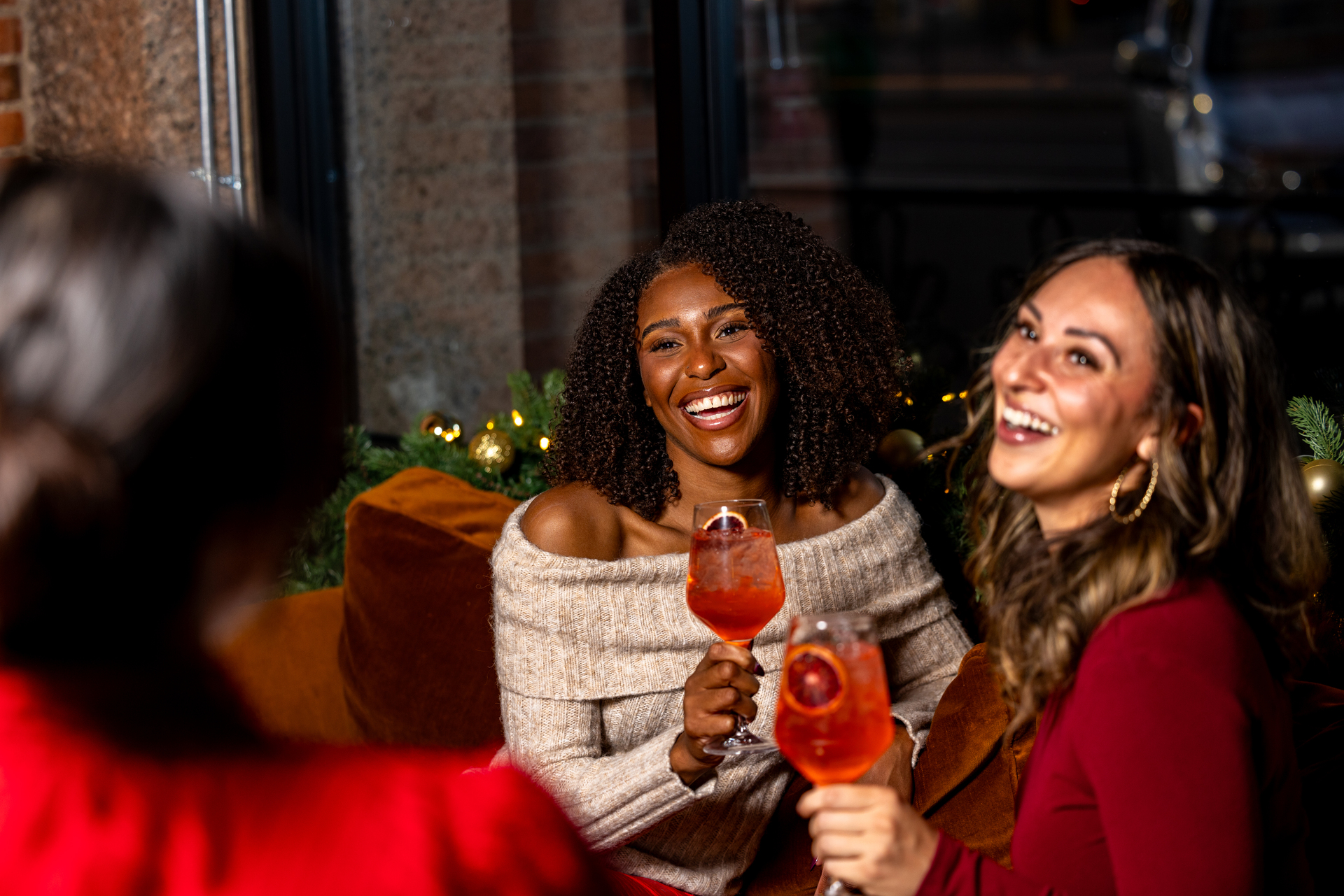 a group of women holding drinks