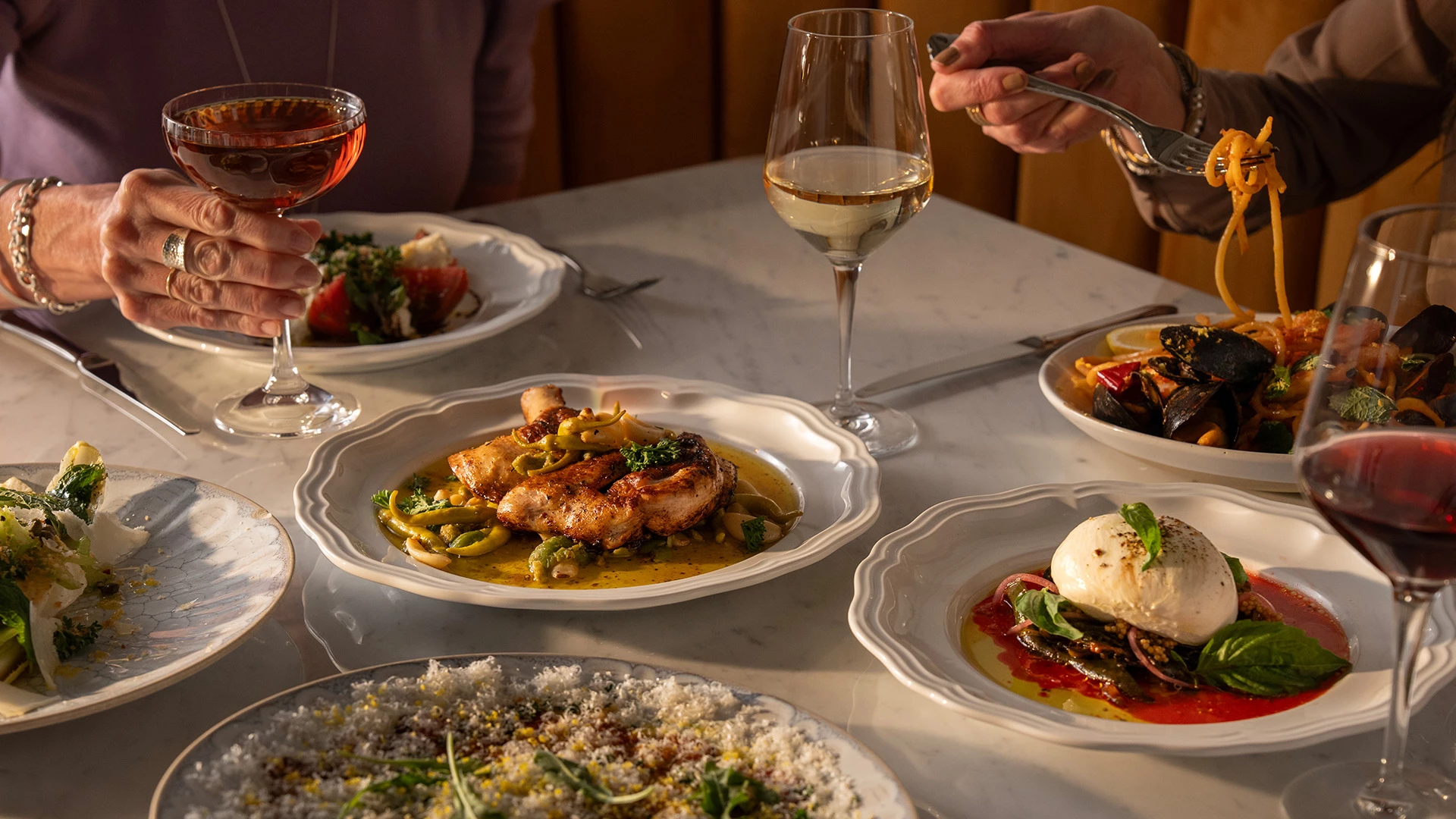 a table with plates of food and wine