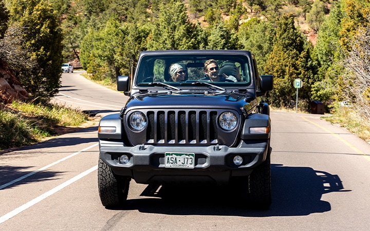 a group of people in a car on a road
