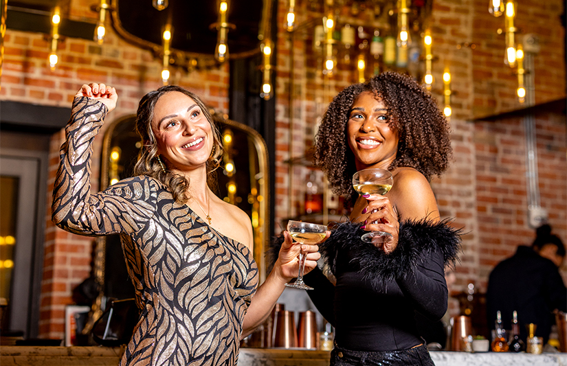 a group of women holding drinks