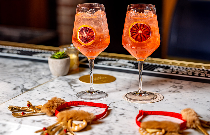 two glasses of orange juice on a table