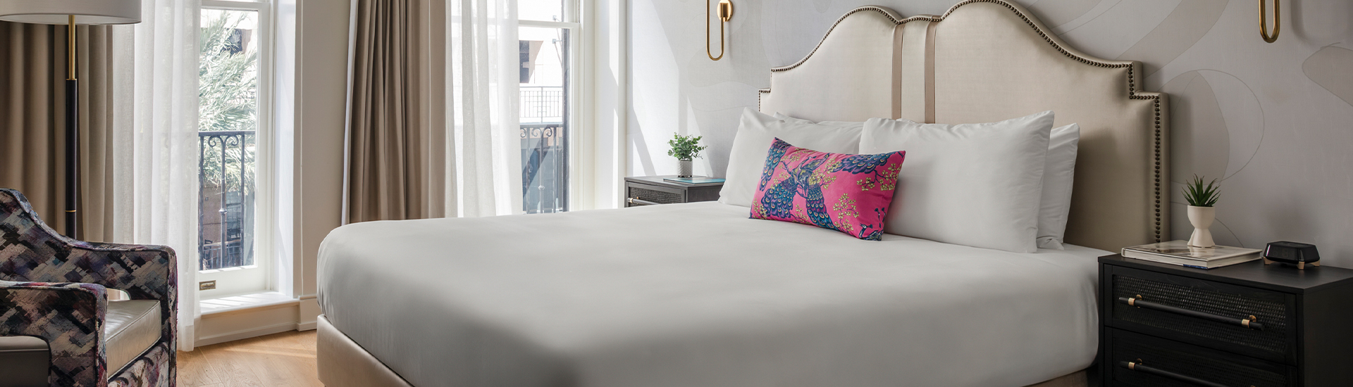 a bed with a pink pillow and a plant on it