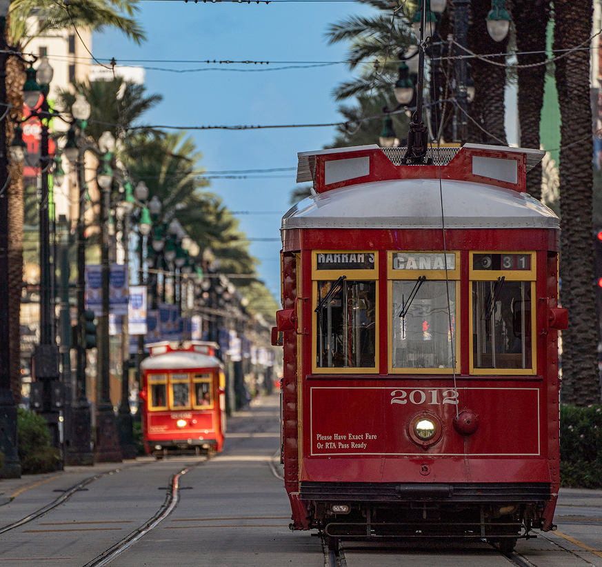 a red trolley cars on a street