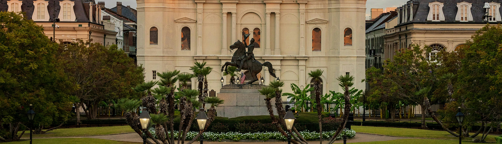 a statue of a man on a horse in front of a building