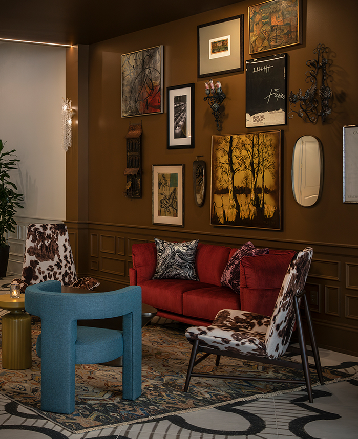 a room with a red couch and chairs