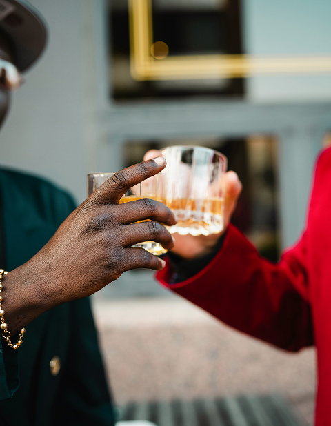 a close up of a person holding a glass