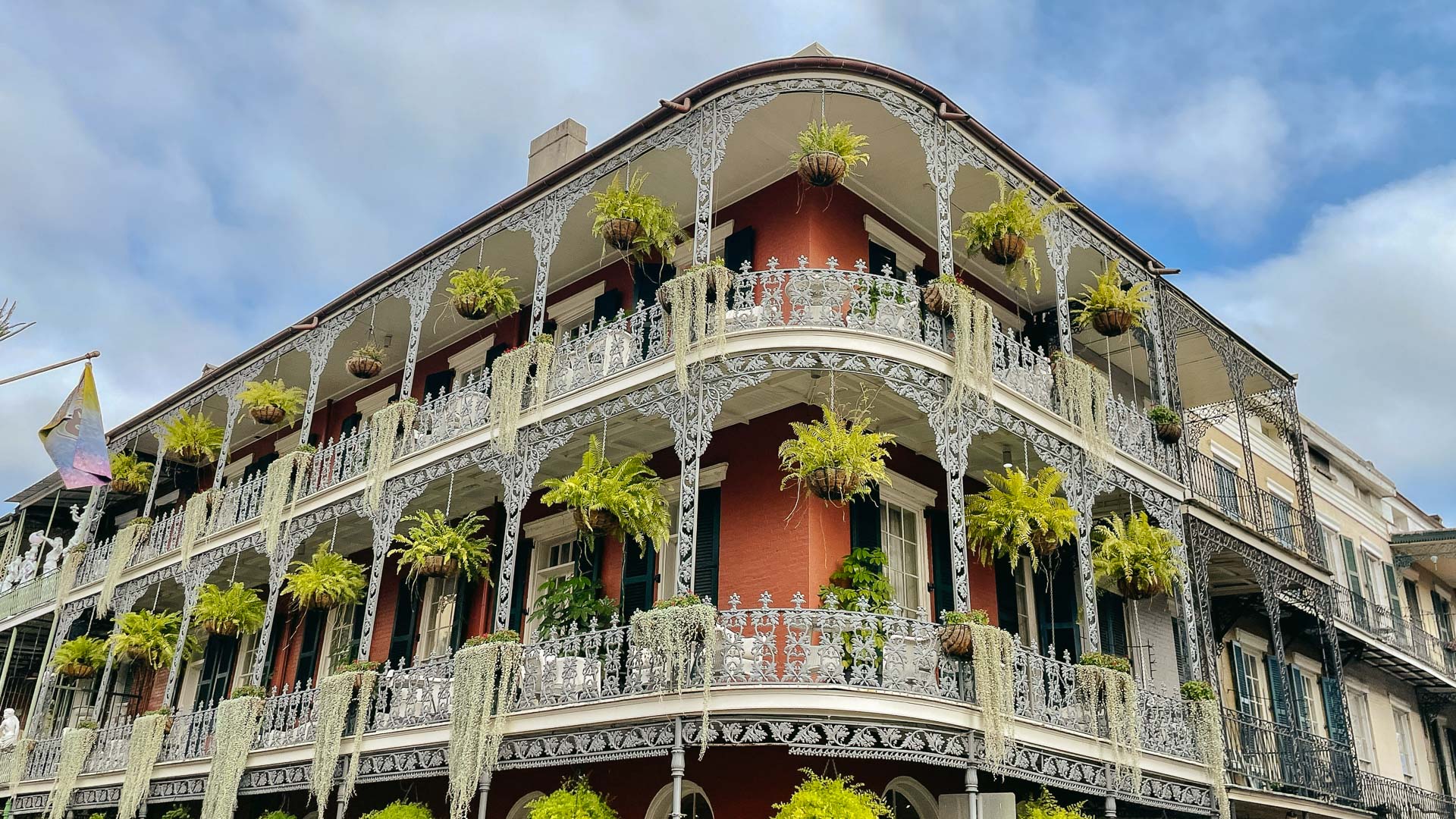 a building with plants on the balcony