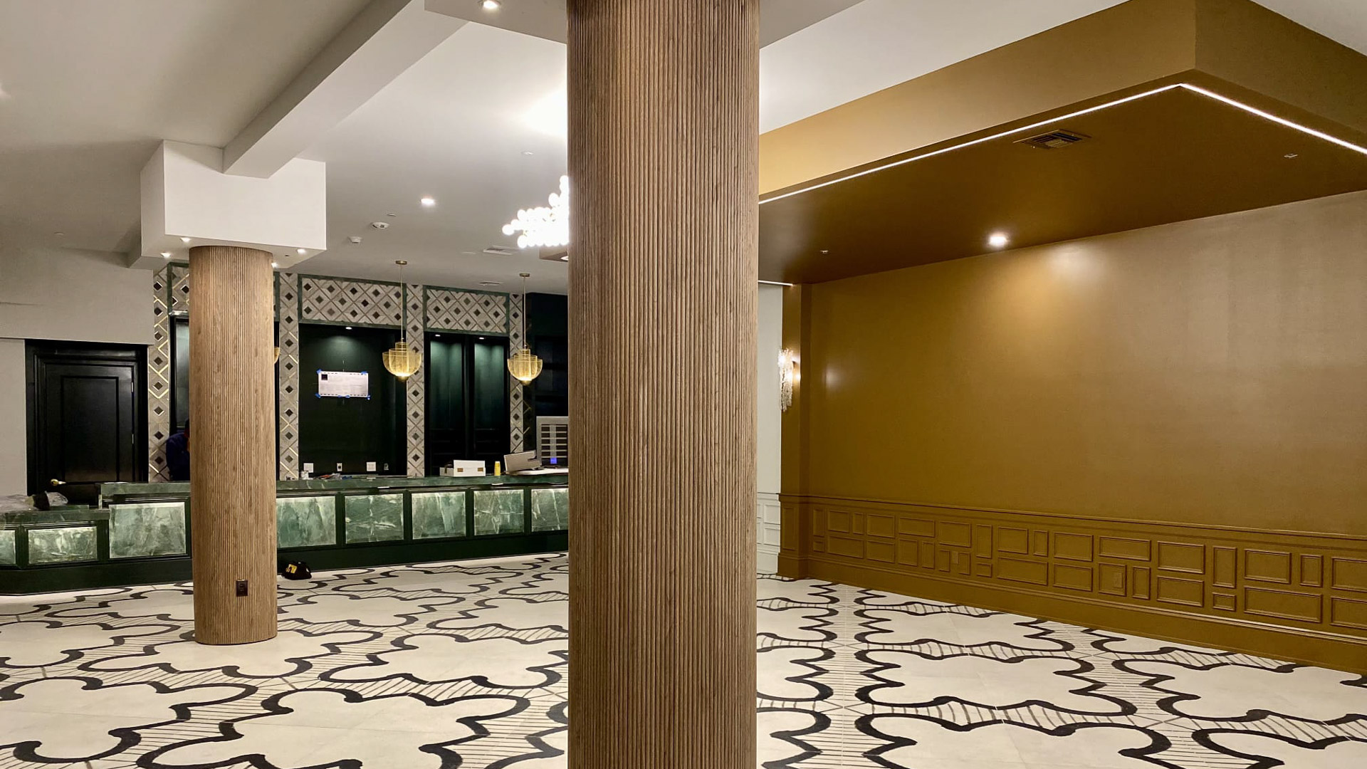 a large room with a reception desk and a marble floor