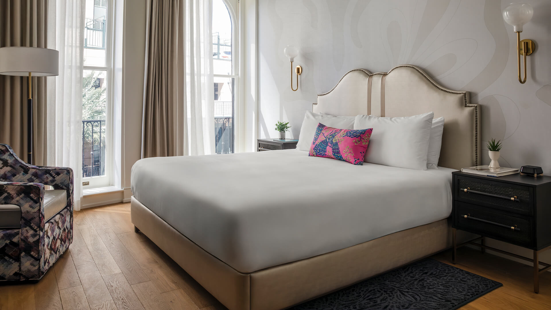 a bed with a pink pillow