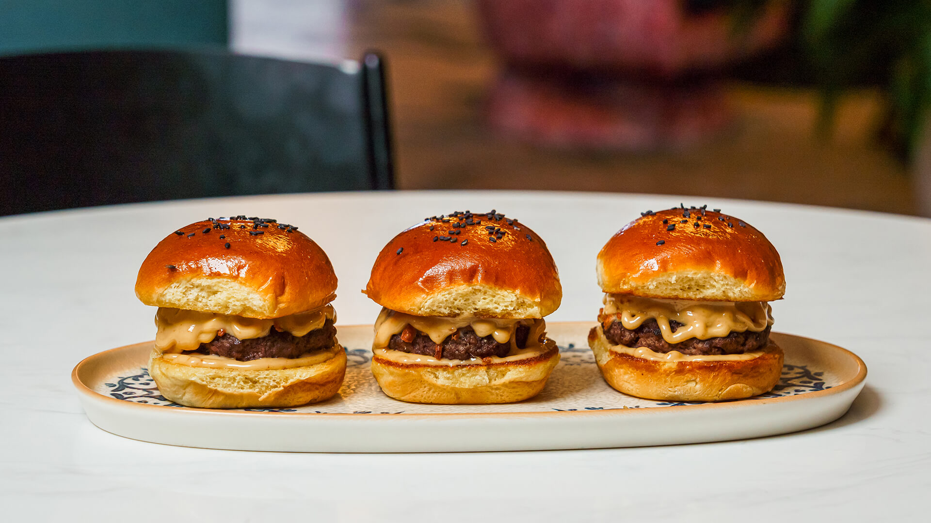 a row of mini burgers on a plate