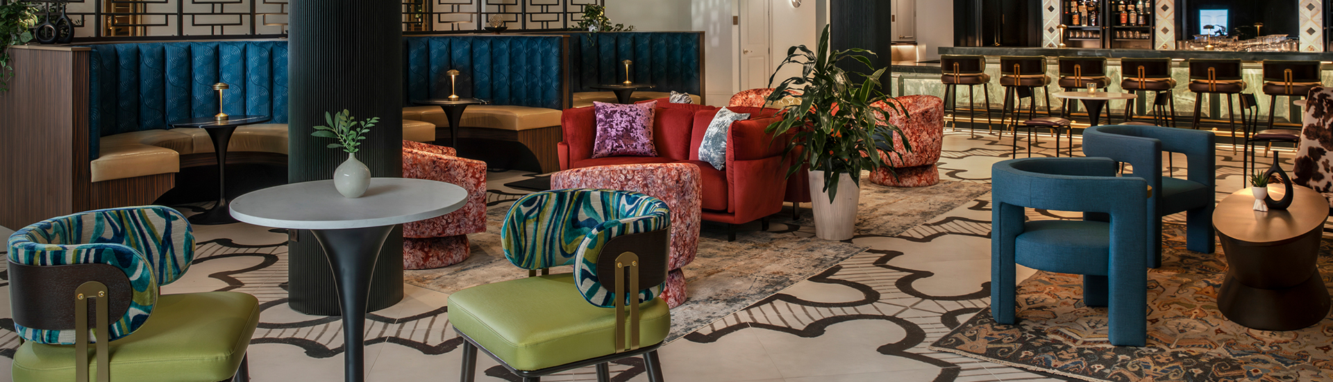 a room with a couch and chairs