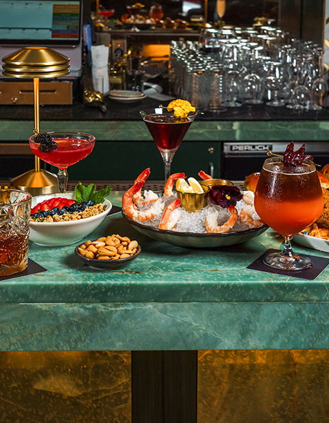 a table with different drinks and food on it