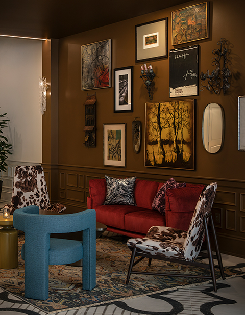 a room with a red couch and chairs