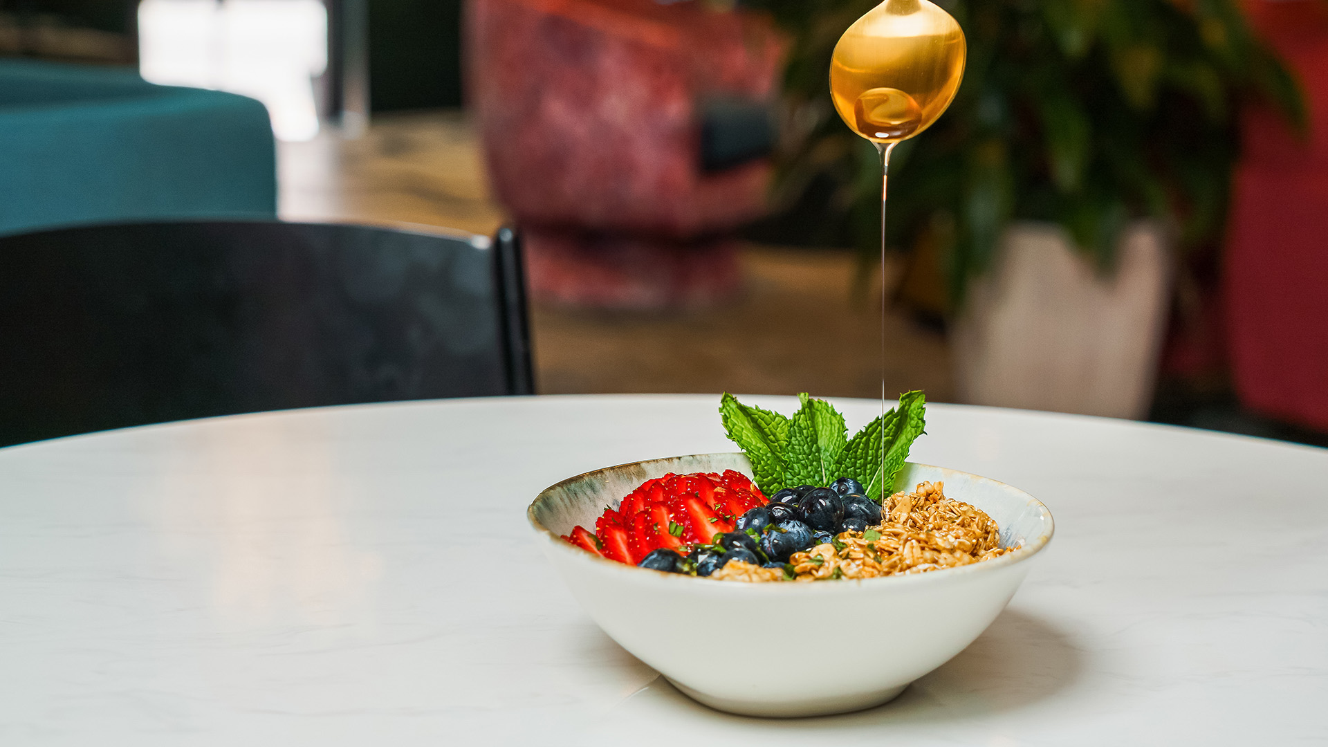a bowl of food with a spoon and a drop of oil