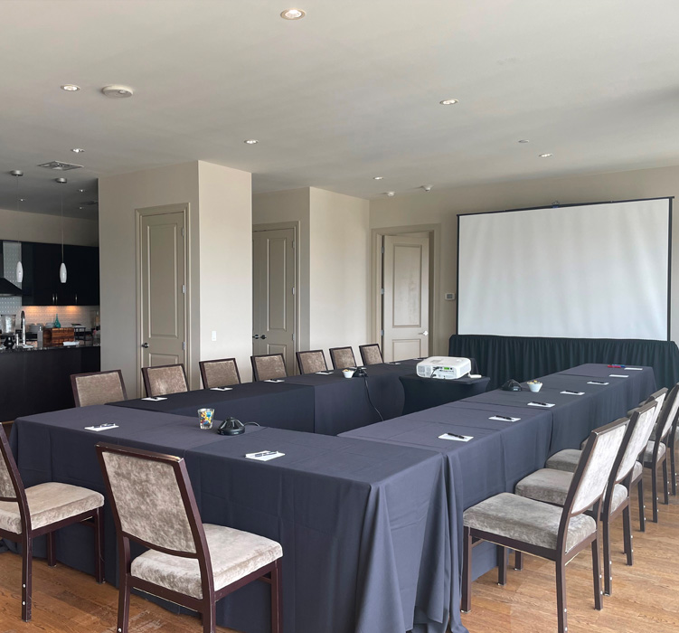 smaller sized meeting room with a small kitchen in the back