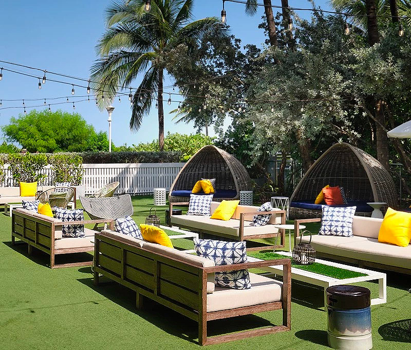 a patio with chairs and a table