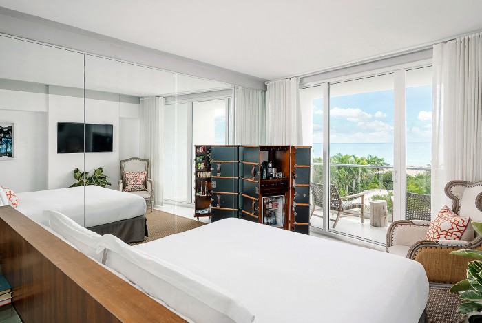 a room with a view of the ocean and chairs
