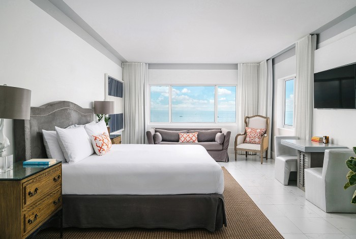 a bed with a white bed and a white wall