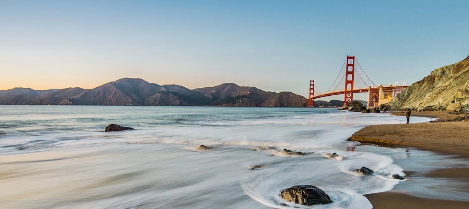 A scenic view of the Golden Gate Bridge and the beach