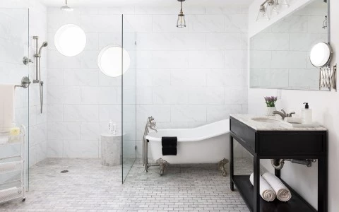 a bathroom with a tub sink and mirror