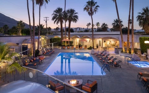 a swimming pool with chairs around it