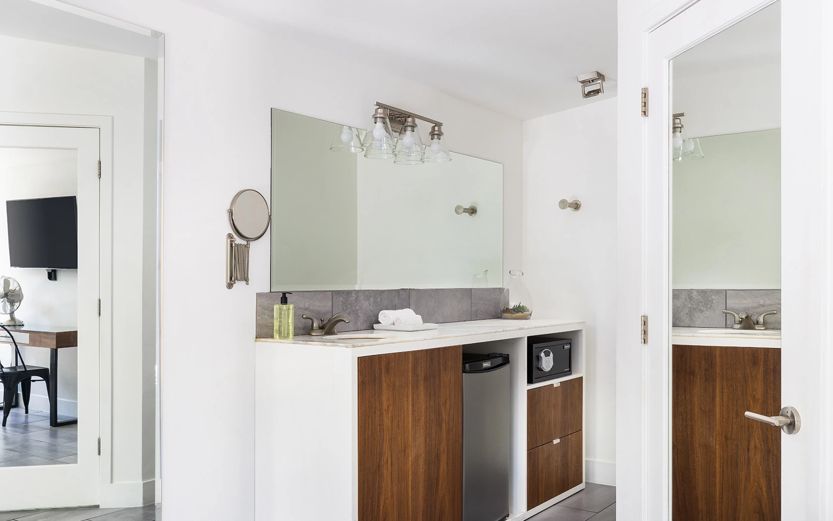 a bathroom vanity with a sink, mirror, and cabinet