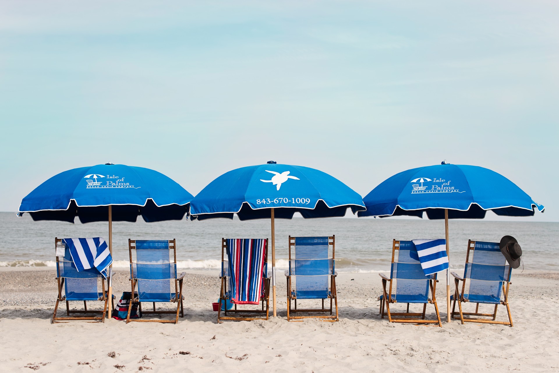 a group of chairs and umbrellas on a beach