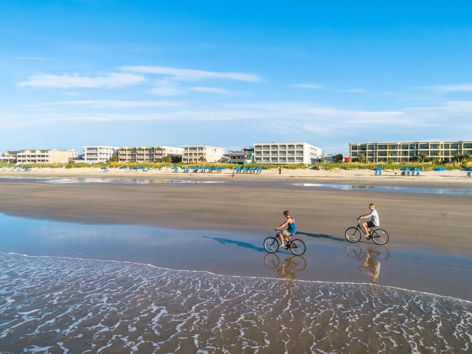people riding bikes on a beach