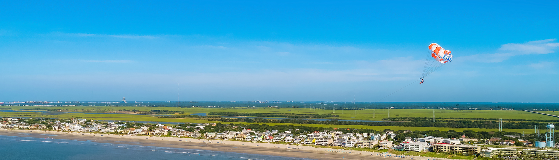 a beach with buildings and a body of water