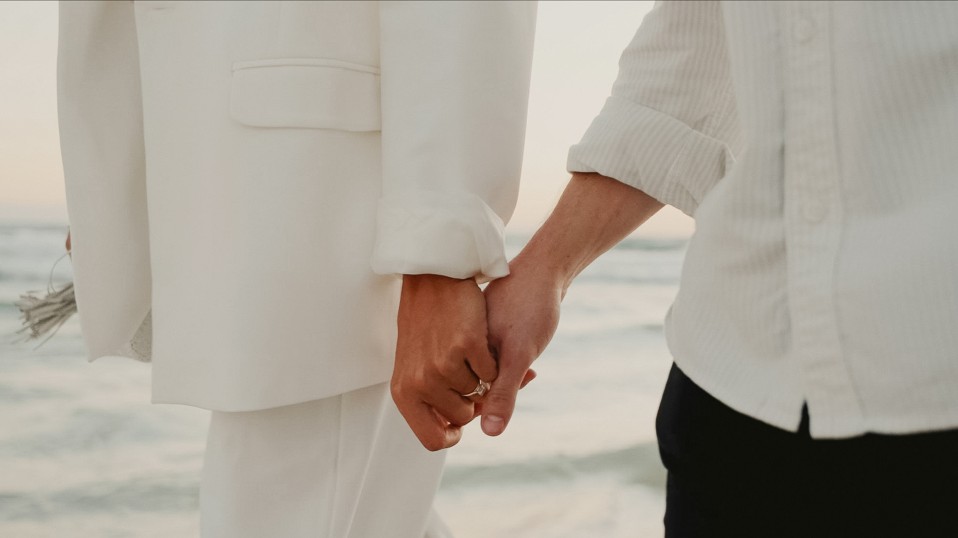 a close up of a couple holding hands