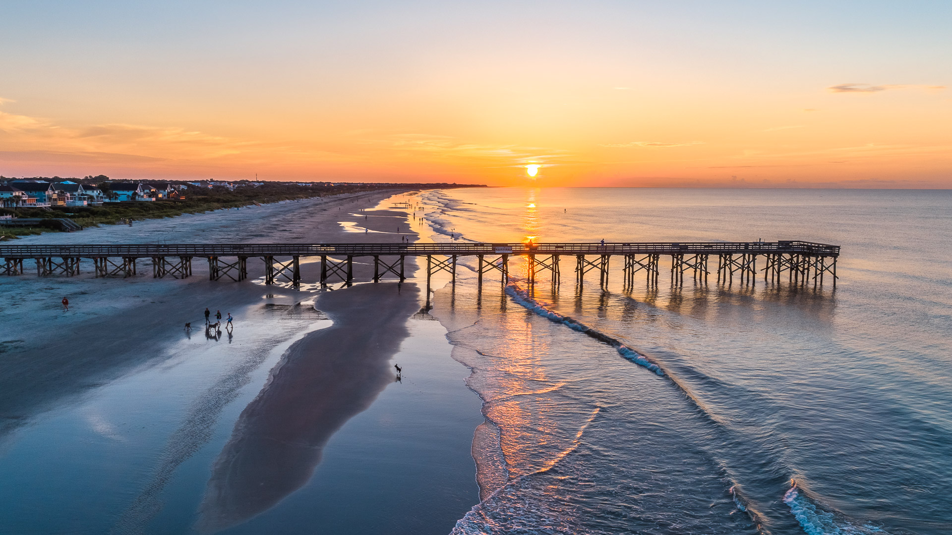 a long wooden bridge over a beach