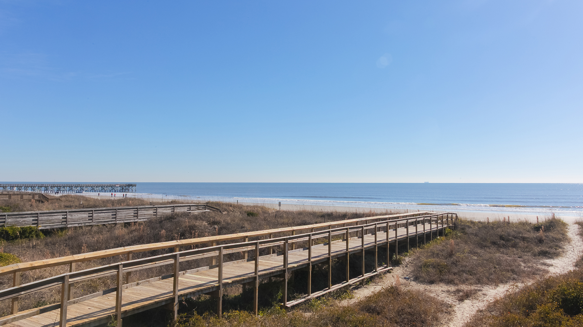 a wooden walkway over a beach