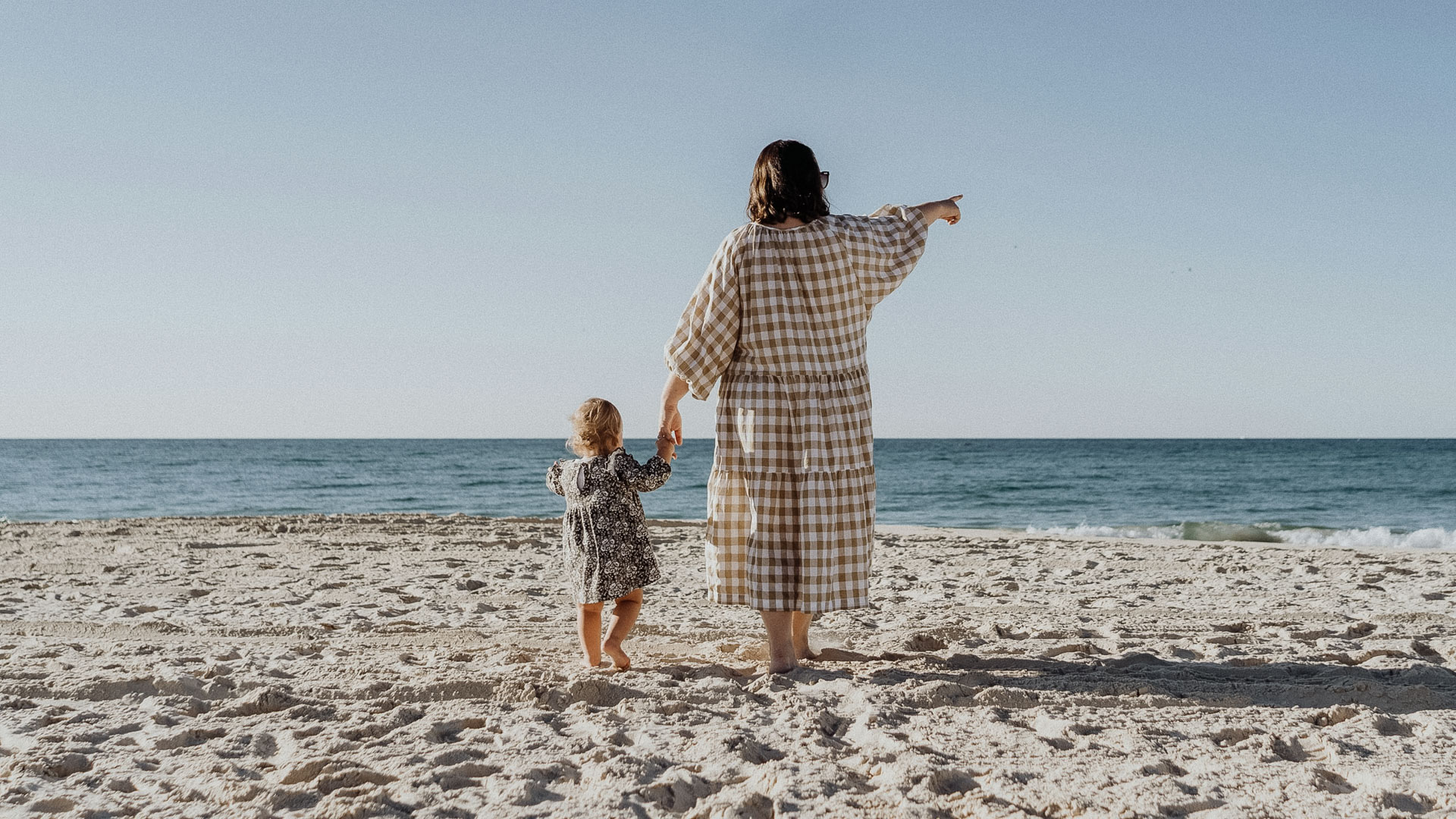 a woman and child on a beach