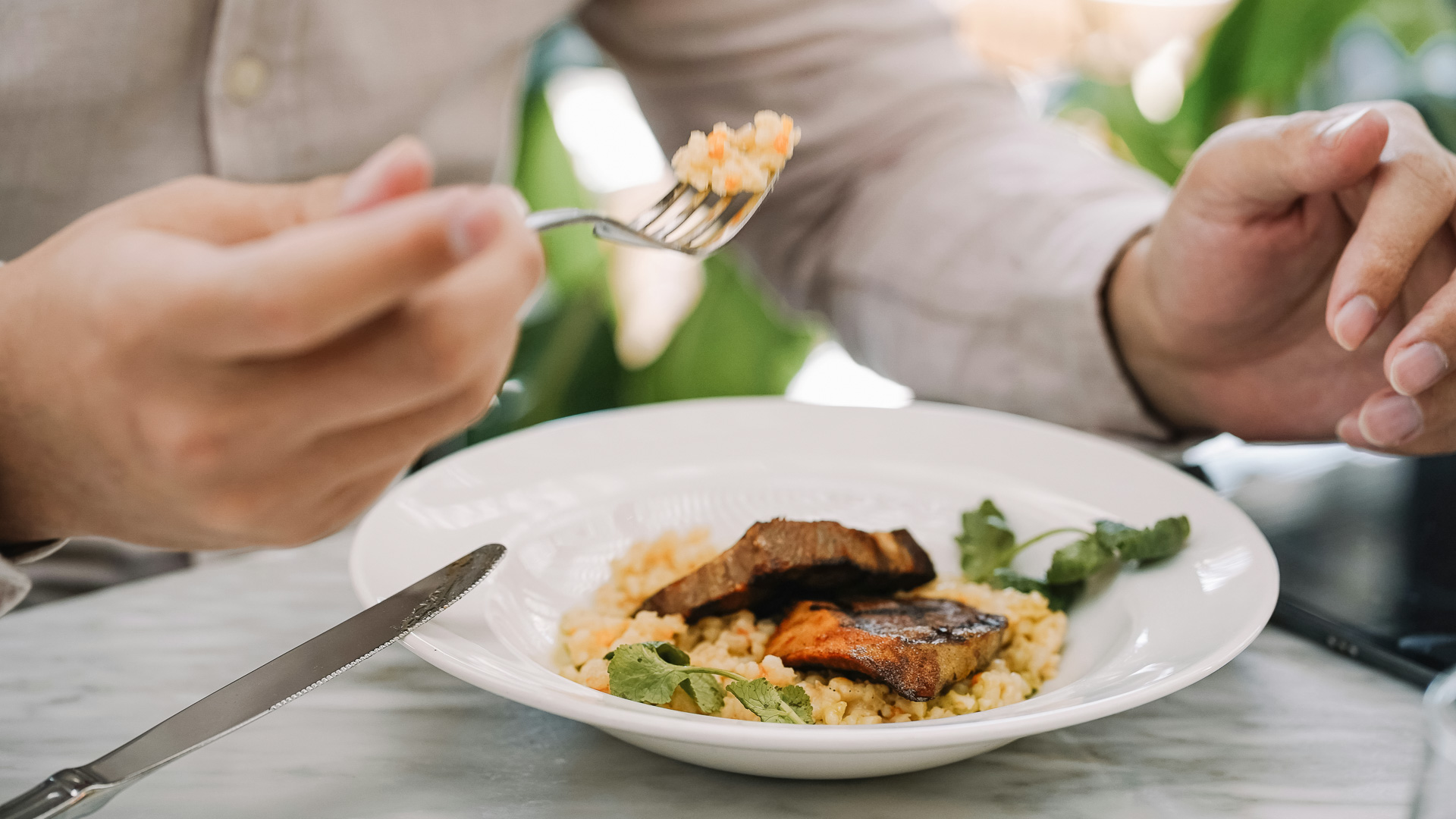 a person eating food on a plate