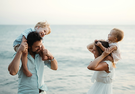 a man and woman with two children on their shoulders