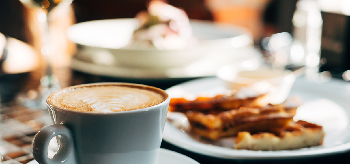 a cup of coffee with a heart shaped foam on top of it