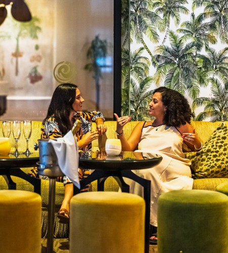 two women sitting on a couch