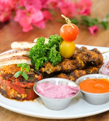 a plate of food with sauces and vegetables