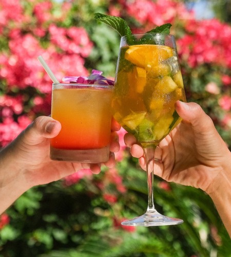 a pair of hands holding drinks