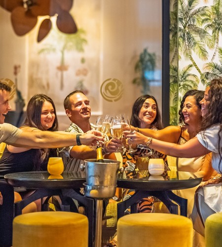 a group of people clinking glasses at a table