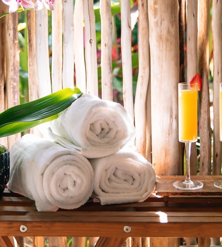 a stack of towels and two glasses of orange juice