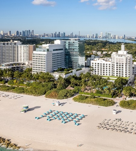 a beach with buildings and trees