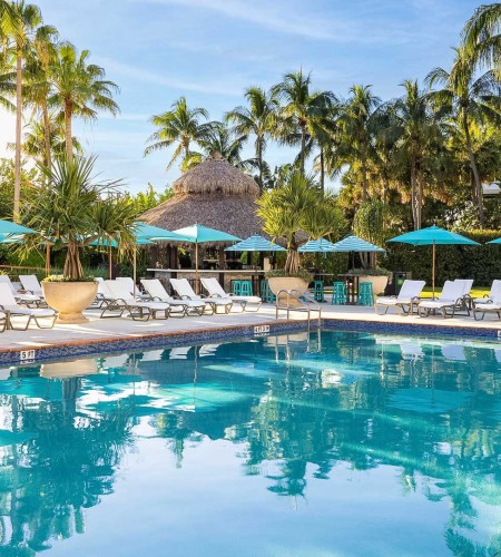 a pool with chairs and umbrellas