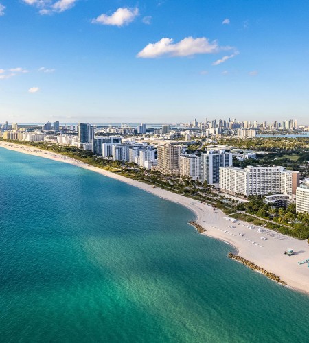 a beach with buildings and a body of water