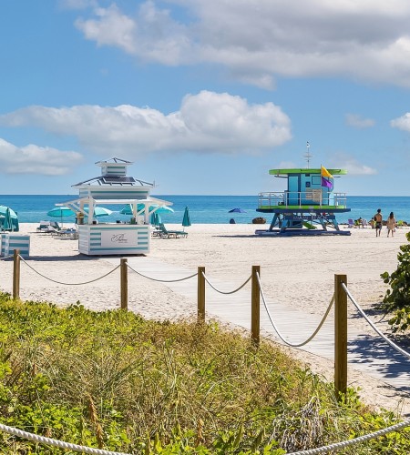 a beach with lifeguard towers and people on the beach